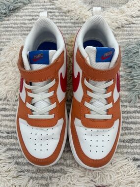 Nike Kids White, Orange & Red Low-Top Sneakers with Blue Tongue Logo